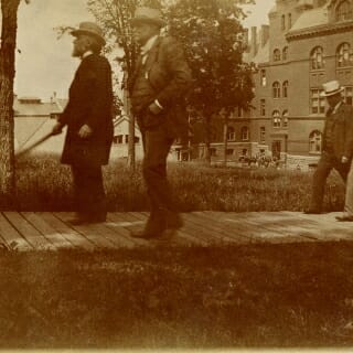 Photo: Adams and Stevens walking up wooden plank sidewalk