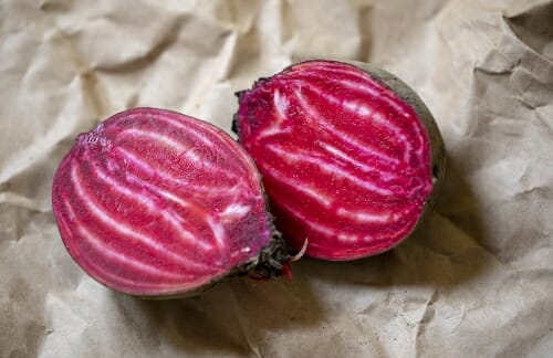 Photo: Two beets lying on a table.