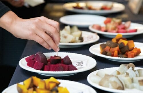 Photo: Plates full of different colored beets on a table.