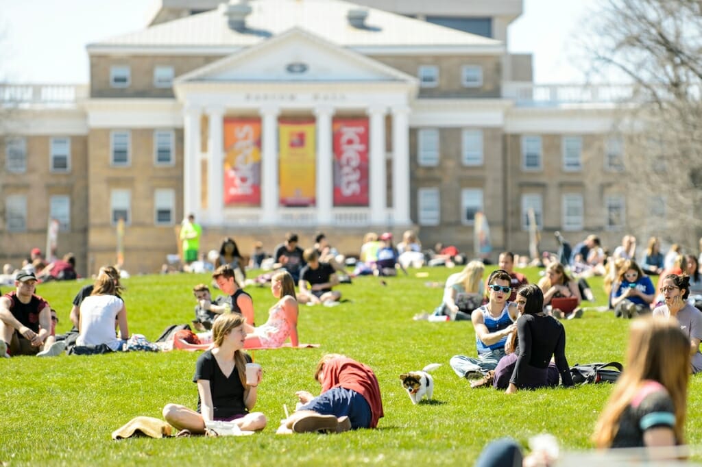 Photo: Students sitting and lying in grass