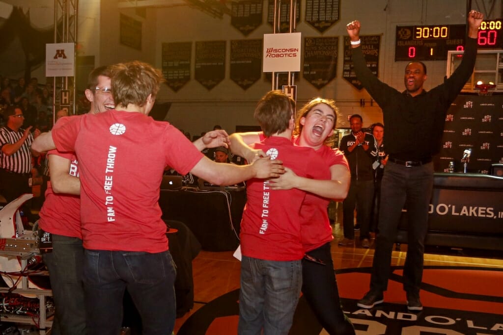 Photo of basketball Hall of Famer David Robinson joining the Wisconsin Robotics team with their victory celebration.