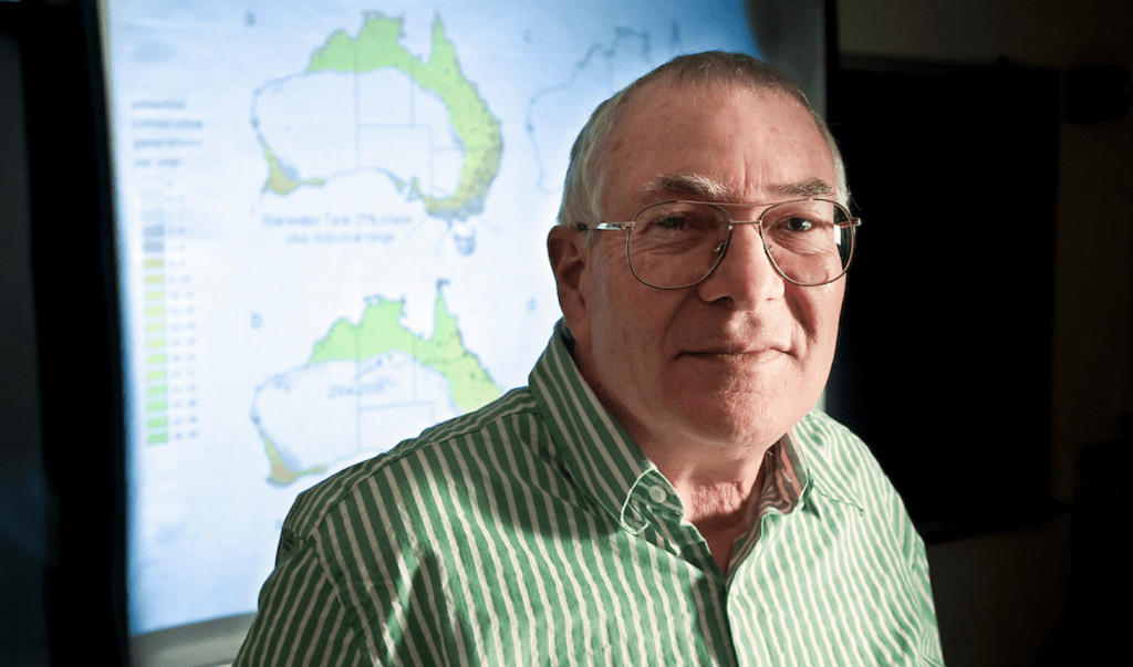 University of Wisconsin–Madison Professor of Zoology, Warren Porter, is pictured in front of a projected map of Australia showing possible future habitat for the mosquito that carries dengue fever. Using software models to predict the spread of the human disease vector, Porter's research team has found that a combination of climate change, evolutionary change, and human behavior are likely to expand the mosquito's range over the next 40 years, increasing the risk of disease transmission.