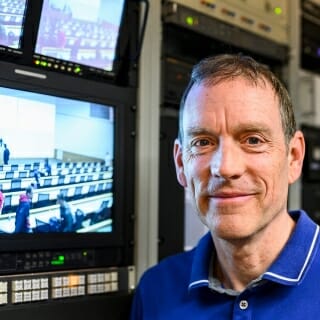 Photo: Jeff in front of computer monitors