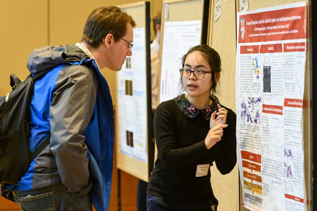 Photo: A student explains to someone her research.