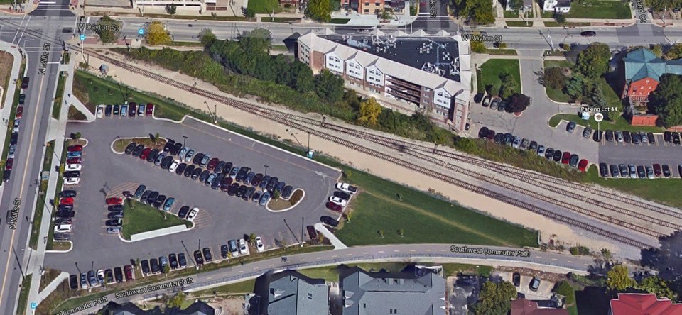 A desire path runs parallel to the railroad tracks on UWs campus.