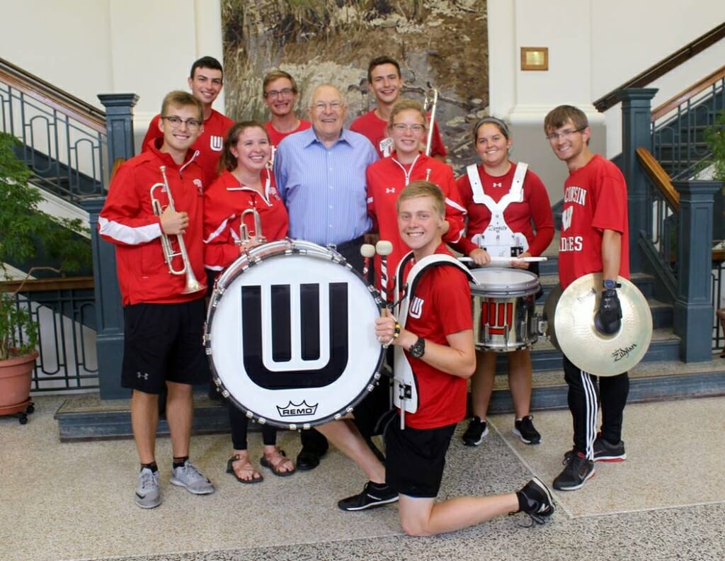 Warren Porter poses with members of the UW Marching Band. 