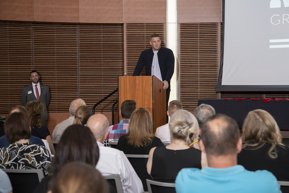 Photo of J.J. Watt speaking at podium.