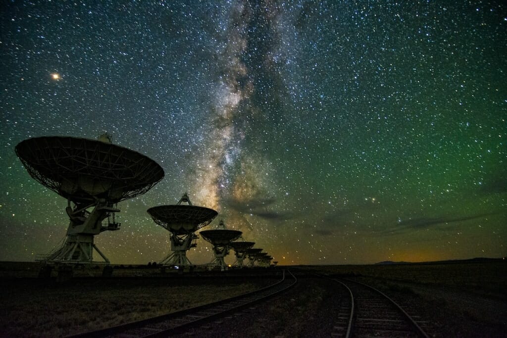 Photo: Satellite dishes at night against starry sky