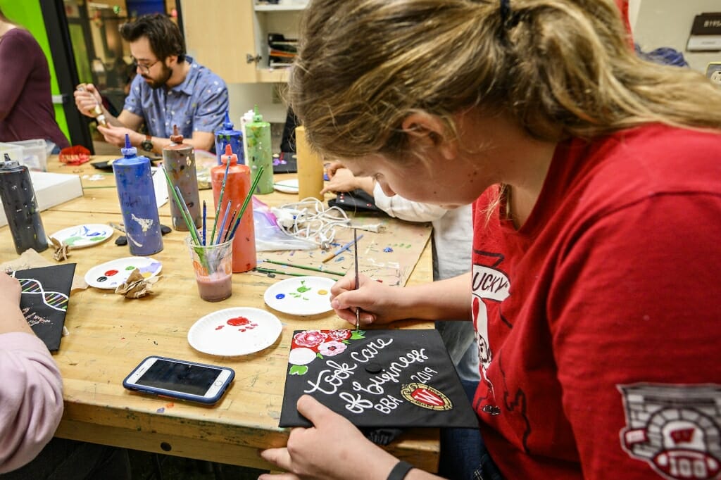 Photo: A woman paints a message on her cap.