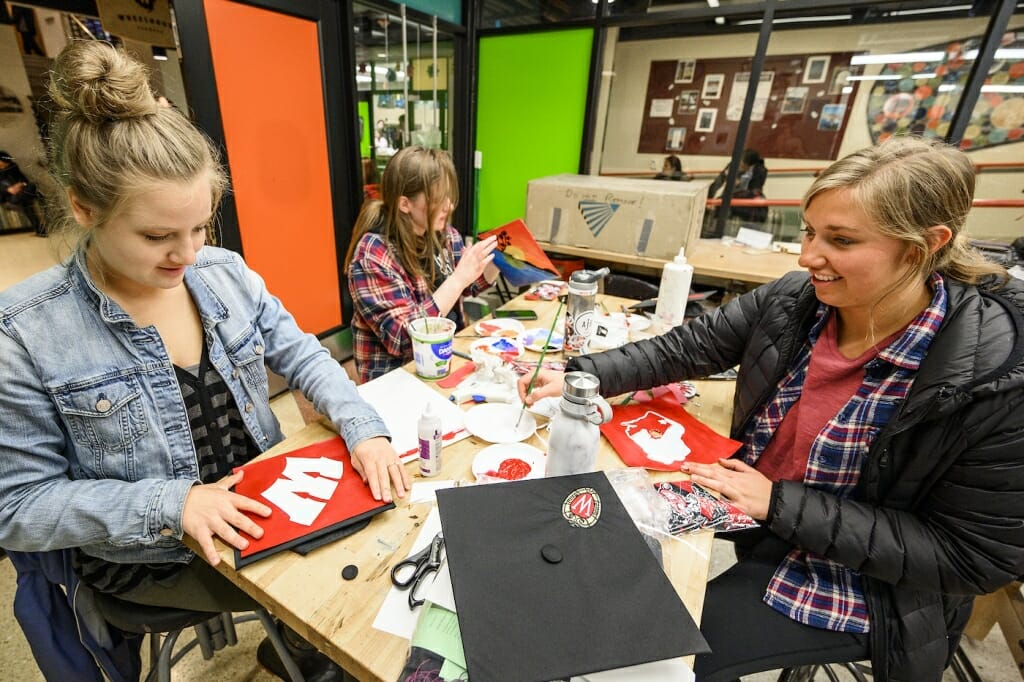 Photo: Three women decorate their caps.