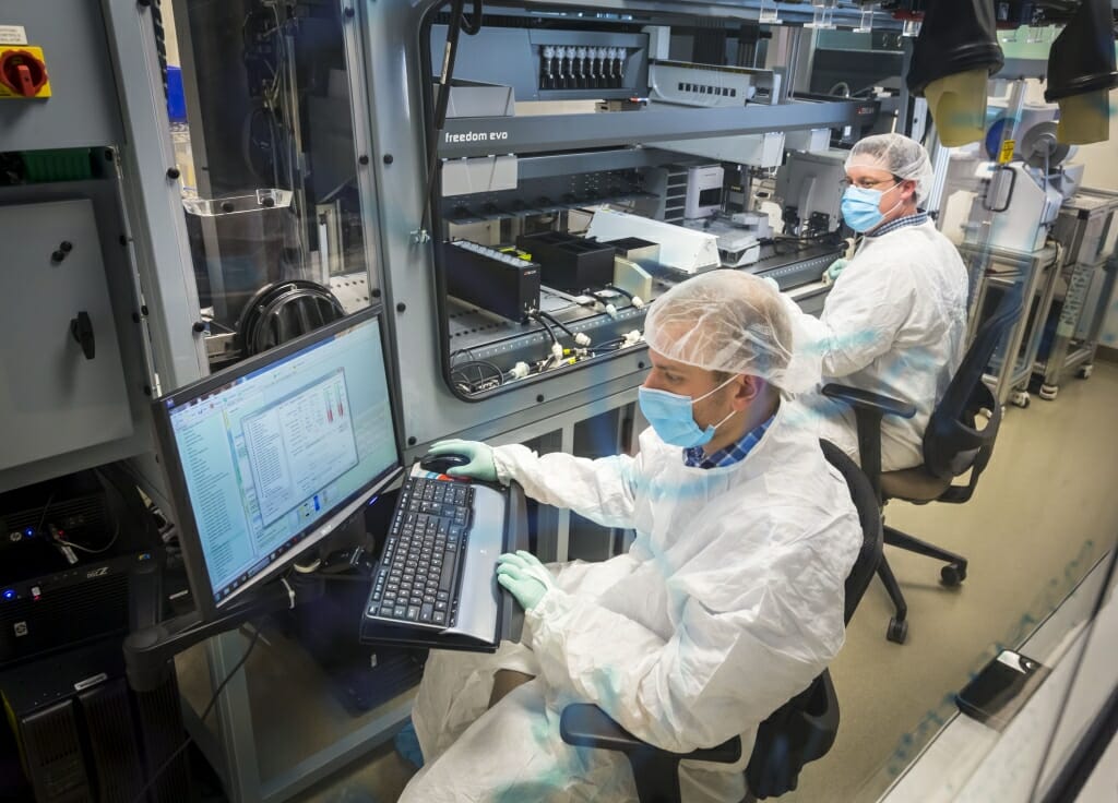 Photo: Two researchers look at a computer screen.