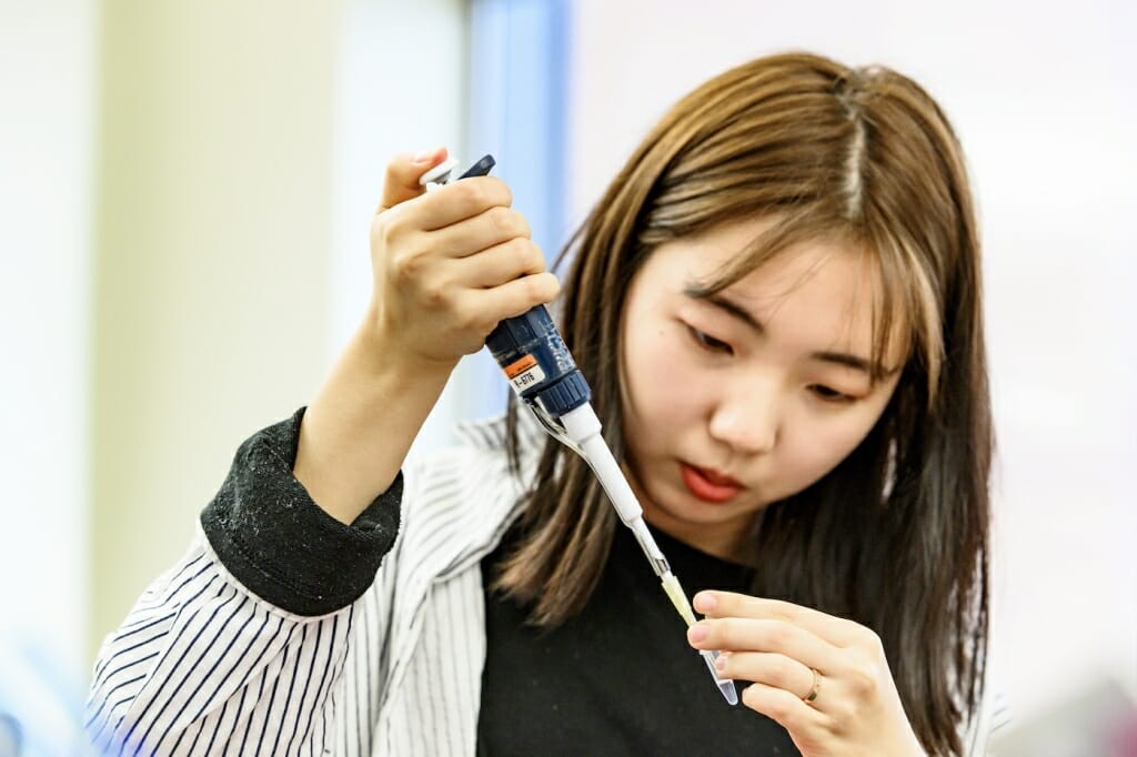 PHoto: A student uses a pipette to grab a specimen.