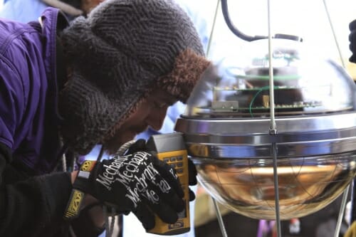 Photo: A scientist looks through an instrument.