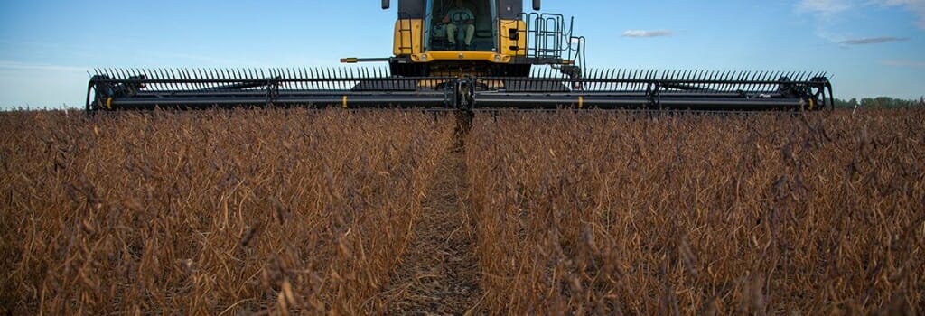 Photo: A harvester rolls through a wheat field.