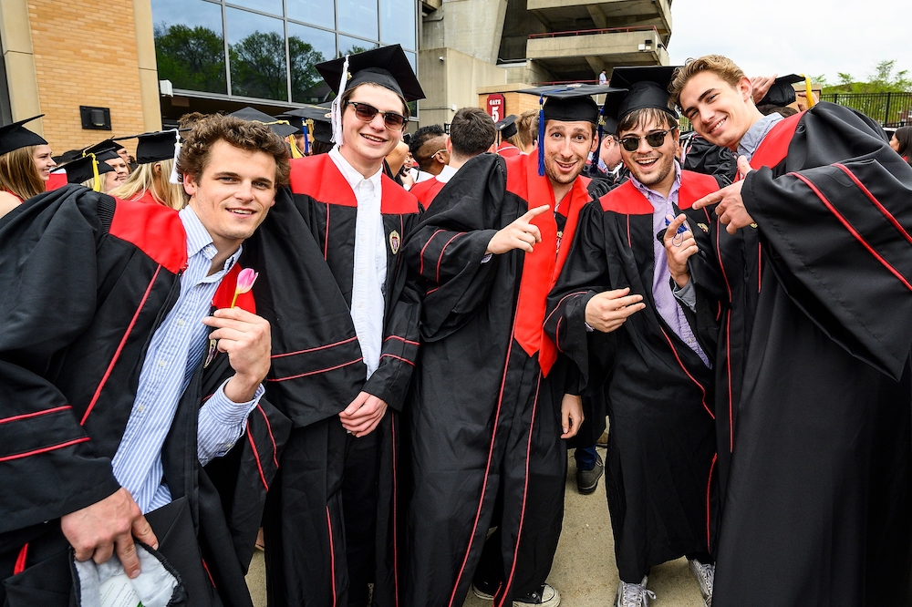 Photo of graduates posing outside Camp Randall.