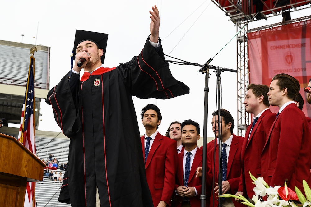 Photo of the UW MadHatters singing on stage.