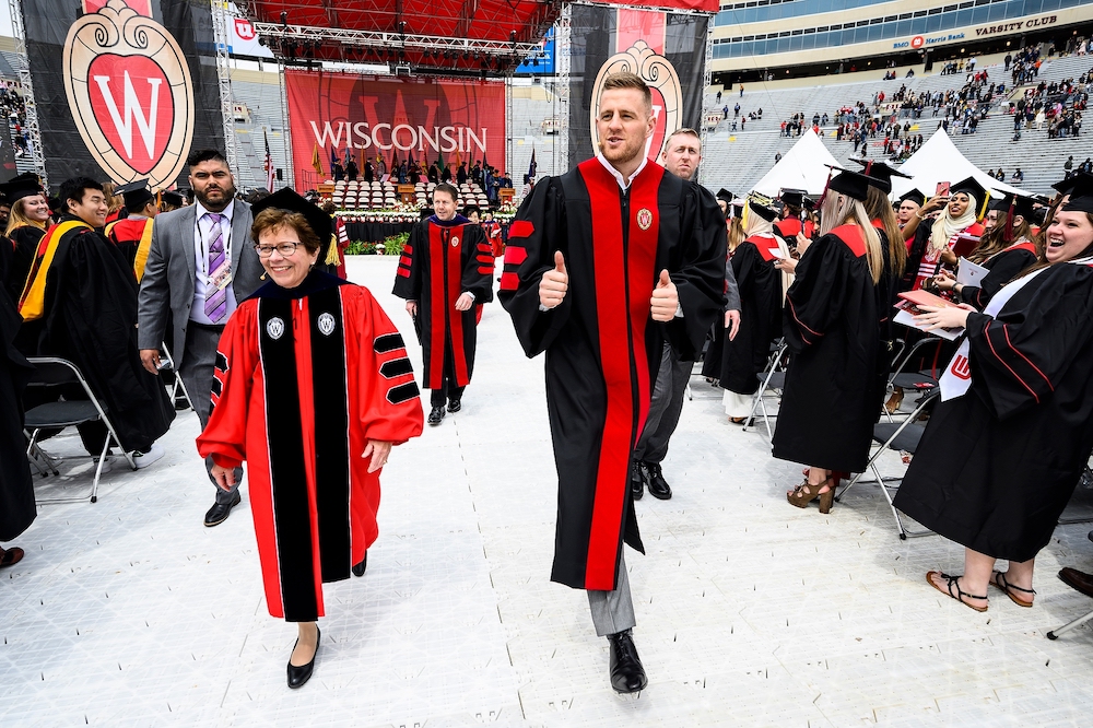 Photo of the chancellor and Watt leading the procession out of the stadium.