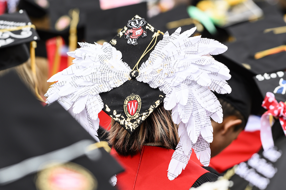 Photo of a mortarboard with wings made out of newsprint