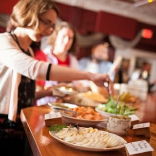 Photo: Amanda taking food from dish