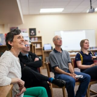 Photo: Seated people listening to speaker