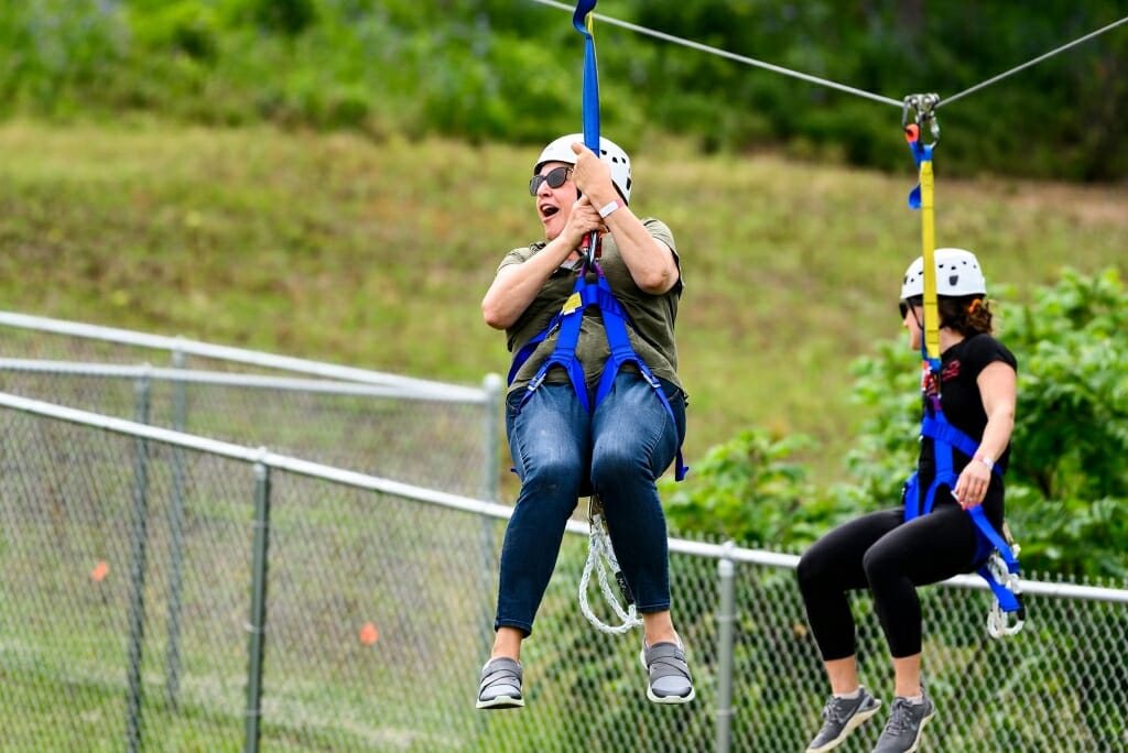 Photo: A woman rides along a zip line