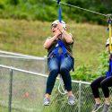 Photo: A woman rides along a zip line