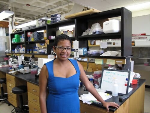 Photo: Aurelie standing in front of lab bench