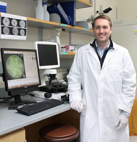 Photo: Warren Rose posing in his lab