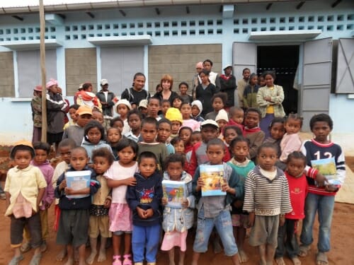 Photo: A group of children on the steps of a school.