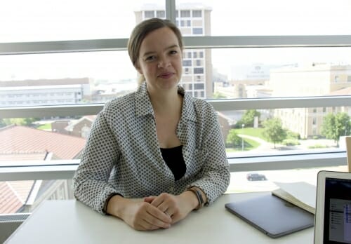 Photo: A woman sits at a desk.