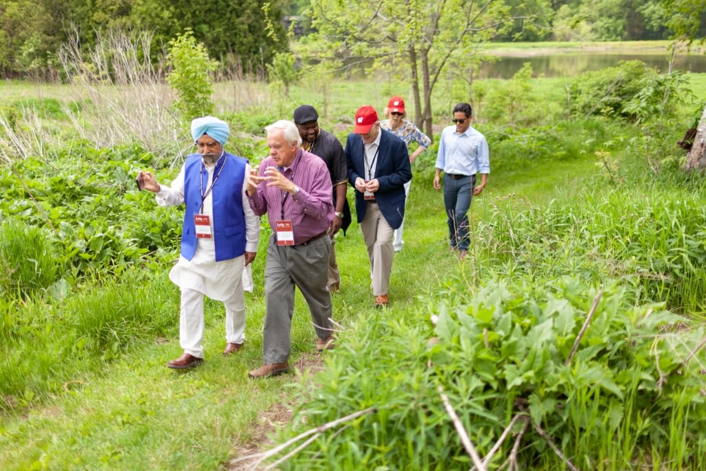 Photo: Group of people walking together on grassy trail