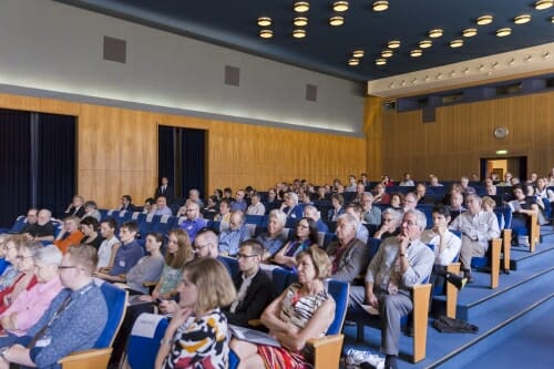 Photo: Crowd of people seated in auditorium