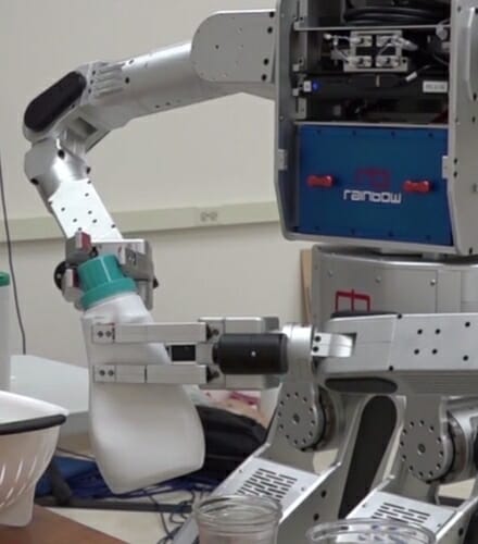 Photo: Robot twisting cap off of plastic jug