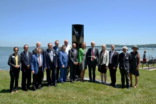 Photo: Group portrait of delegation standing in front of sculpture