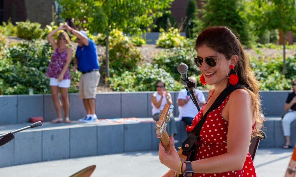 Photo: A woman plays her guitar