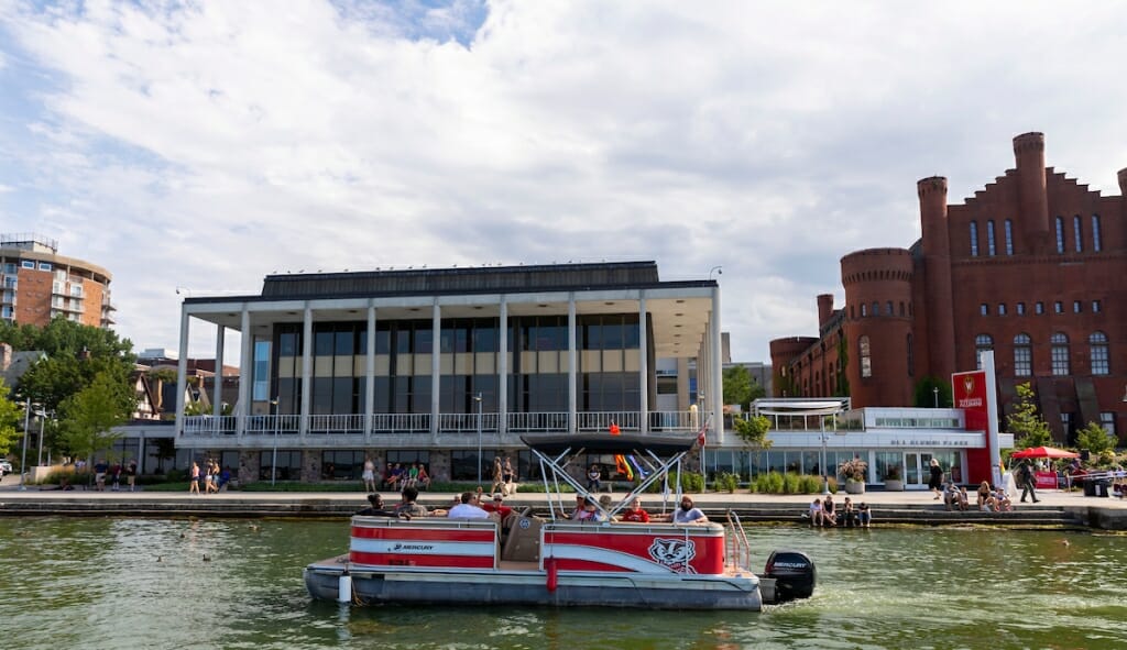 Photo: A pontoon boat floats near the shore of Lake Mendota.