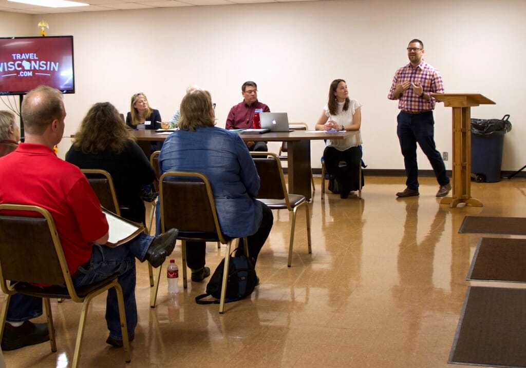 Photo: An audience listens attentatively to a presentation.