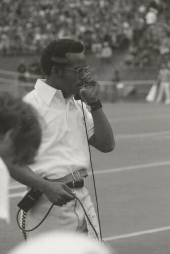 Photo: Martin speaking into headset on sideline