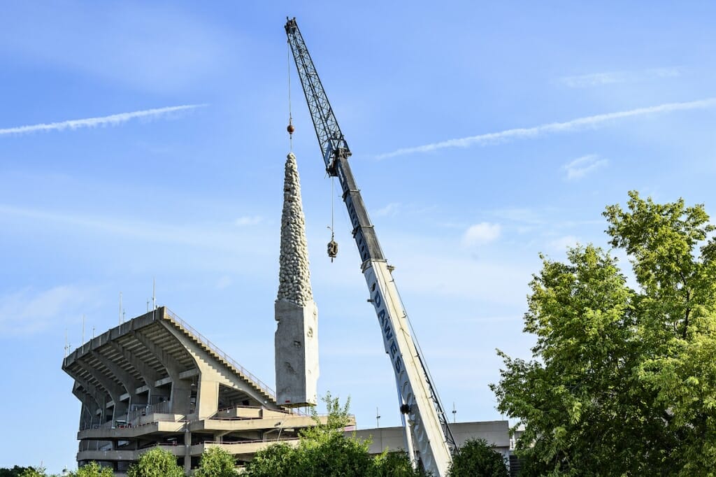 Photo: A crane transports a large statue.