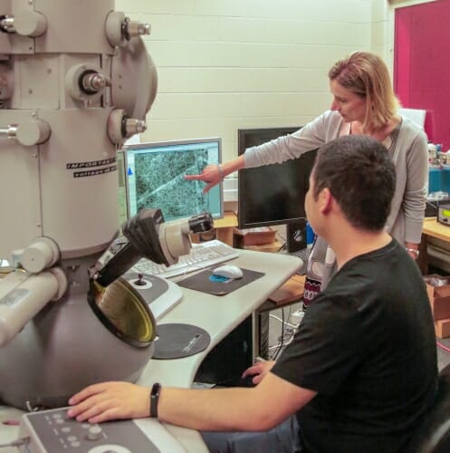 Photo: Woman pointing at screen while man looks