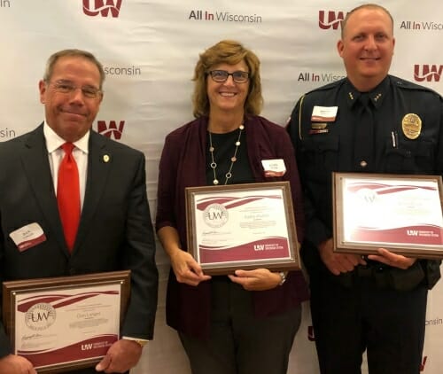 Photo: Langer, Mather and Plisch standing together holding plaques