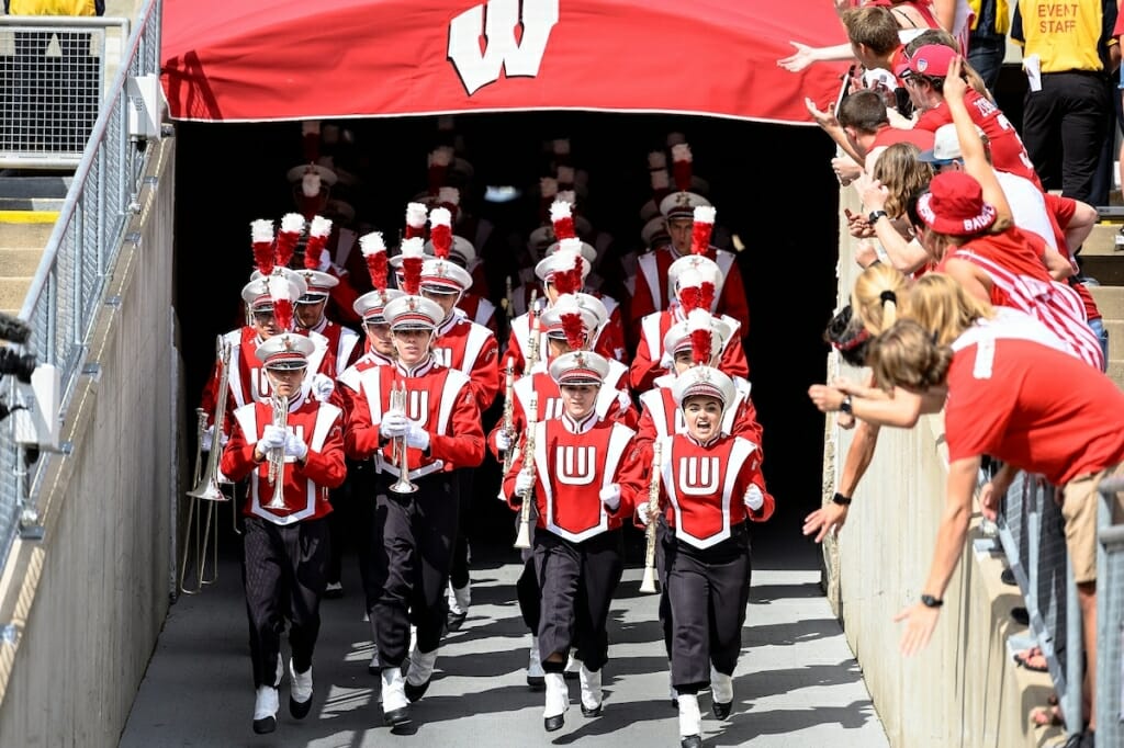 Photo: Uniformed band members marching through tunnel