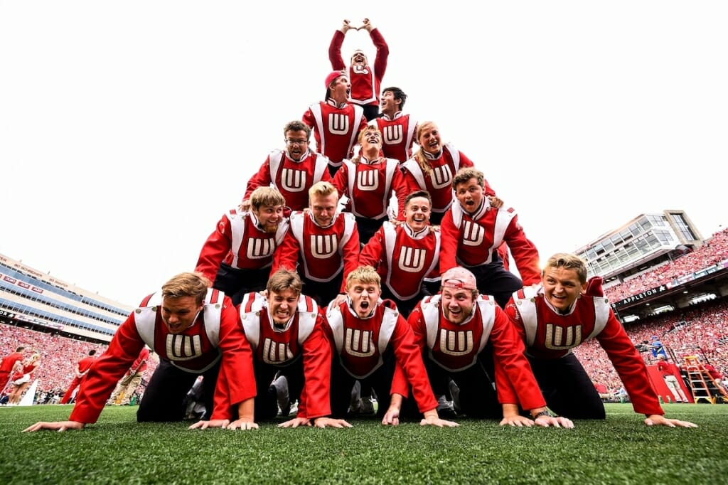 Photo: Band members in uniform making human pyramid