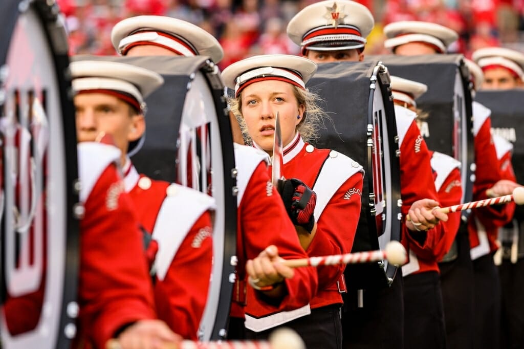 Photo: Band members marching with drums and cymbals