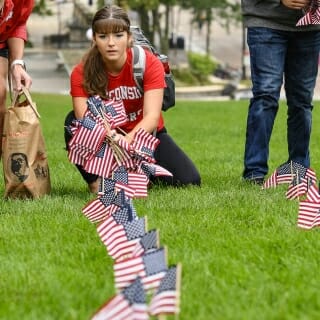 Photo: A student looks at a row of flags.