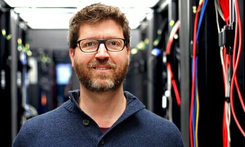 Photo: Wimmers standing between computers taller than he is