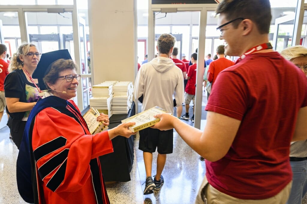 Photo: Blank handing book to student