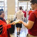 Photo: Blank handing book to student