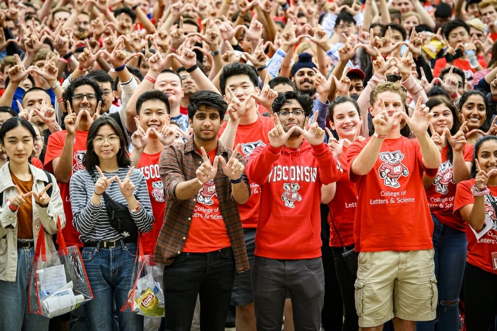 Photo: A crowd of red-clad freshman mug for the camera.