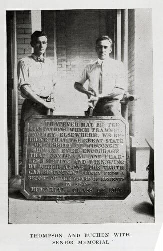 Photo: Students standing behind plaque placed on floor